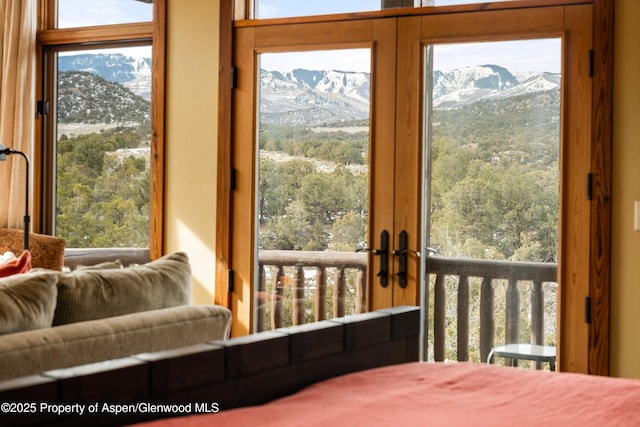 bedroom featuring multiple windows and a mountain view