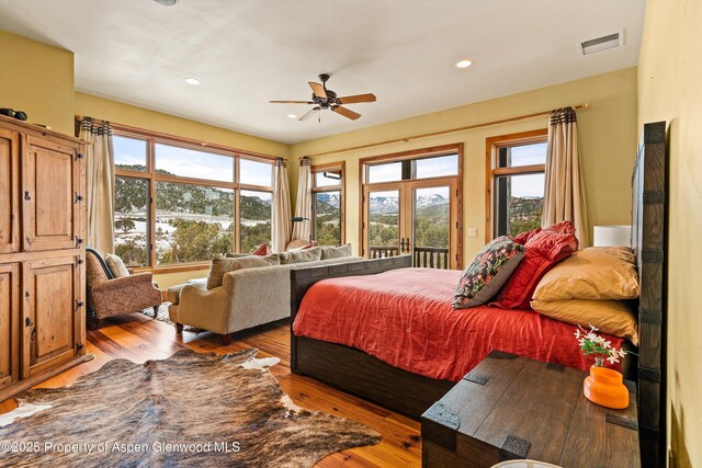 bedroom featuring visible vents, ceiling fan, hardwood / wood-style floors, access to exterior, and recessed lighting