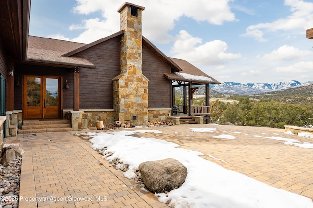 view of patio / terrace featuring a mountain view and french doors