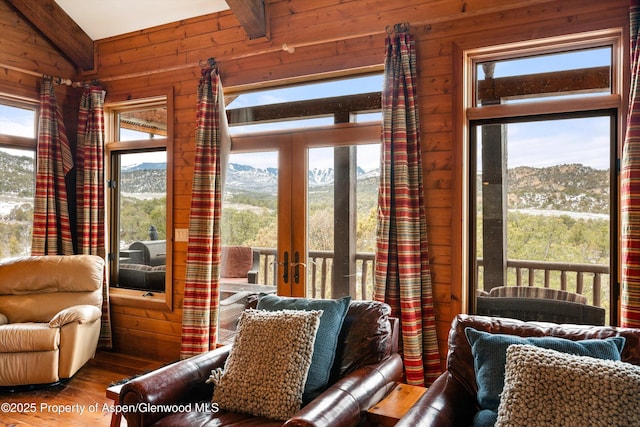 sunroom / solarium with a mountain view and french doors