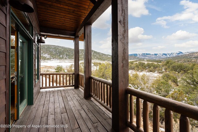 wooden deck with a mountain view