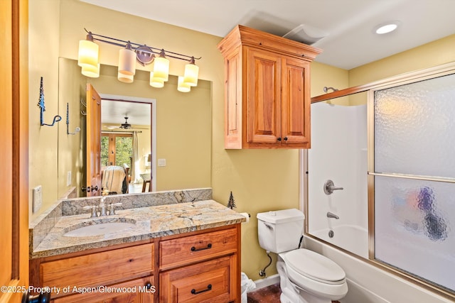 full bathroom featuring toilet, vanity, and bath / shower combo with glass door