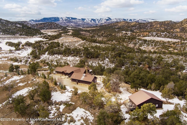 snowy aerial view with a mountain view