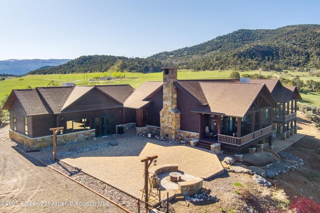 857 Indian Rock Rd, Silt, CO 81652 - view of front of property with stone siding, a chimney, and a porch