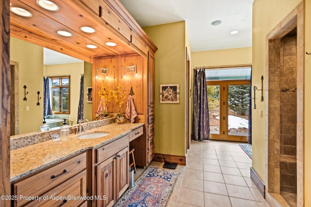 full bath featuring recessed lighting, tile patterned flooring, baseboards, and vanity