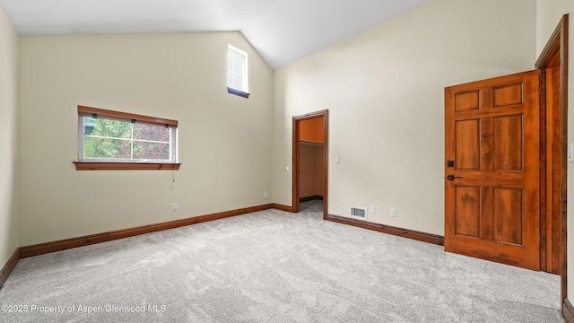 225 Juniper Ct, Basalt, CO 81621 - unfurnished bedroom with high vaulted ceiling, carpet floors, and a walk in closet
