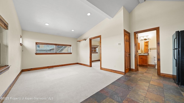 225 Juniper Ct, Basalt, CO 81621 - unfurnished room with vaulted ceiling, carpet, stone finish flooring, and recessed lighting