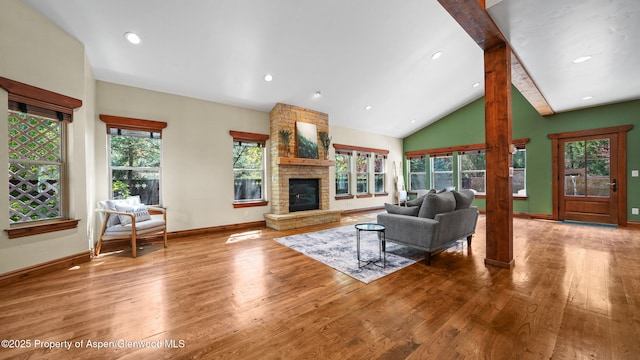 225 Juniper Ct, Basalt, CO 81621 - living room featuring wood finished floors, a fireplace, decorative columns, beam ceiling, and recessed lighting