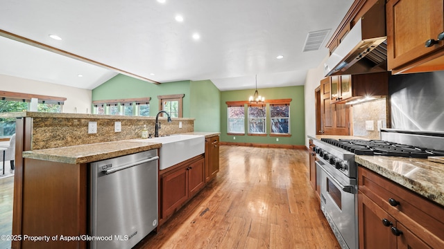 225 Juniper Ct, Basalt, CO 81621 - kitchen featuring stainless steel appliances, extractor fan, backsplash, light wood-style flooring, and a chandelier