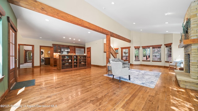 225 Juniper Ct, Basalt, CO 81621 - living area with recessed lighting, a stone fireplace, light wood-style flooring, beam ceiling, and high vaulted ceiling