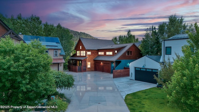 225 Juniper Ct, Basalt, CO 81621 - view of front of house with a garage, driveway, an outbuilding, roof mounted solar panels, and a yard