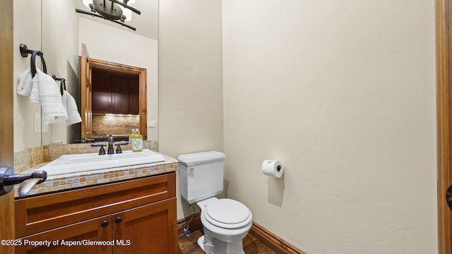 225 Juniper Ct, Basalt, CO 81621 - half bathroom featuring vanity, tasteful backsplash, and wood finished floors