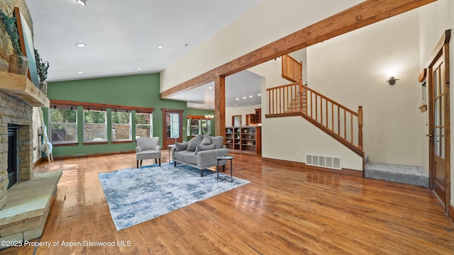 225 Juniper Ct, Basalt, CO 81621 - living area featuring a fireplace with raised hearth, stairs, wood finished floors, recessed lighting, and high vaulted ceiling