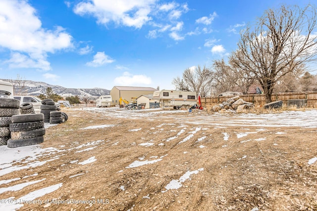 snowy yard featuring a mountain view