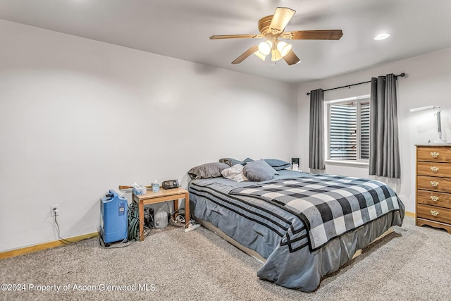 bedroom with ceiling fan and carpet floors