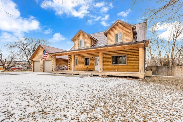 log home with a porch and a garage