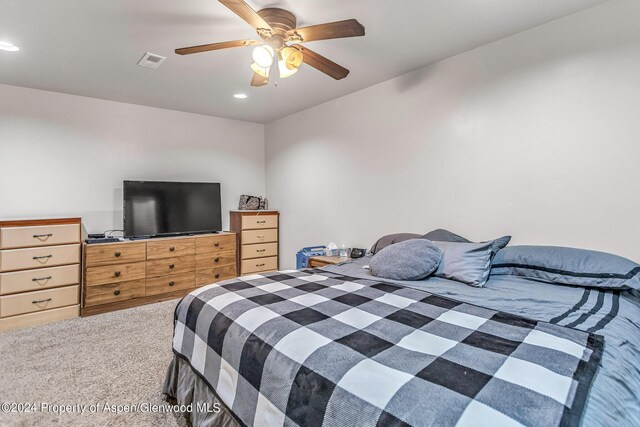 bedroom with ceiling fan and carpet floors