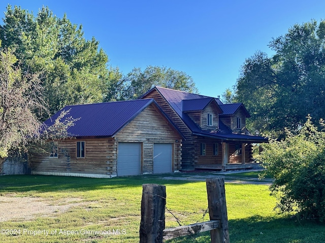 log home with a front lawn and a garage