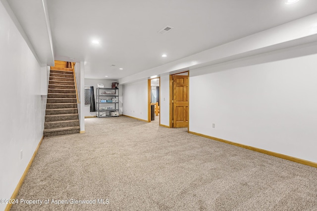 basement featuring light carpet