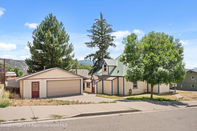 440 Whiteriver Ave, Rifle, CO 81650 - view of front of home with a detached garage, a metal roof, and a mountain view