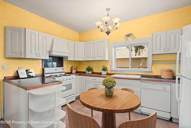 440 Whiteriver Ave, Rifle, CO 81650 - kitchen with white appliances, premium range hood, a chandelier, and dark countertops