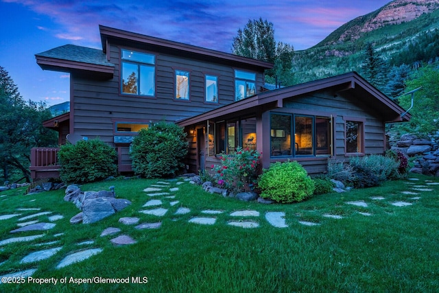 606 Dorais Way, Redstone, CO 81623 - back of property at dusk with a mountain view and a lawn