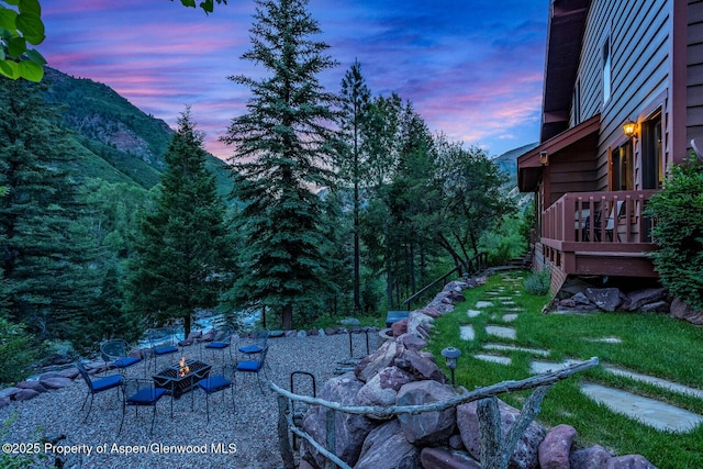 606 Dorais Way, Redstone, CO 81623 - yard at dusk featuring a fire pit and a wooden deck