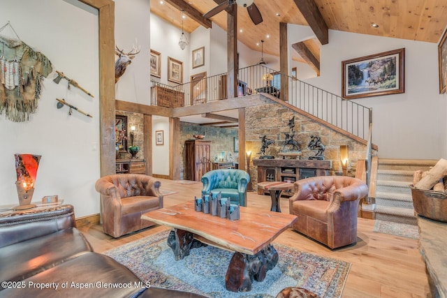 606 Dorais Way, Redstone, CO 81623 - living area with beam ceiling, wood finished floors, high vaulted ceiling, stairway, and a ceiling fan