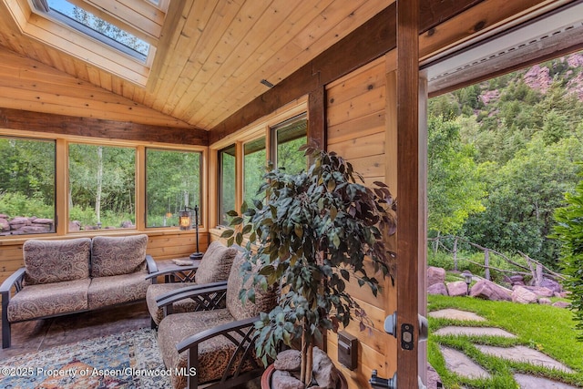 606 Dorais Way, Redstone, CO 81623 - sunroom featuring a skylight, vaulted ceiling, wood walls, and wood ceiling