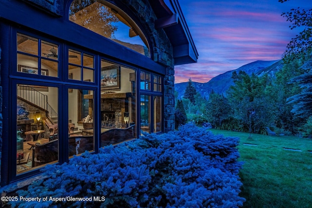 606 Dorais Way, Redstone, CO 81623 - view of side of home featuring stone siding, a mountain view, and a lawn