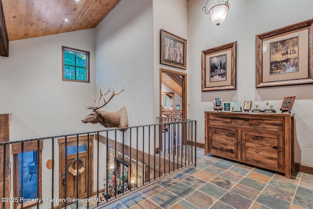 606 Dorais Way, Redstone, CO 81623 - hall with an upstairs landing, stone tile flooring, wooden ceiling, recessed lighting, and lofted ceiling
