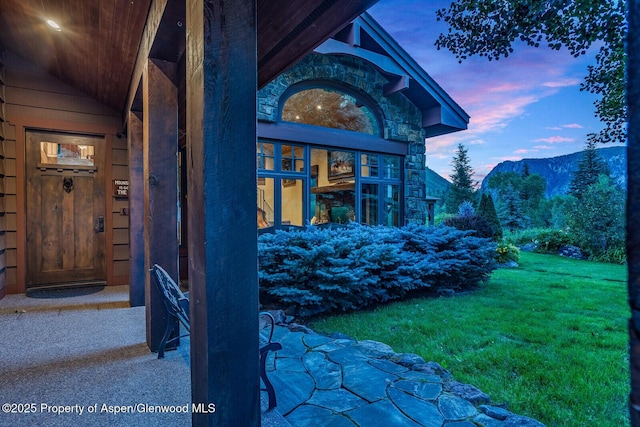 606 Dorais Way, Redstone, CO 81623 - exterior entry at dusk with a yard and a mountain view