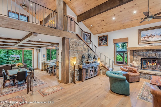 606 Dorais Way, Redstone, CO 81623 - living area with a fireplace, hardwood / wood-style floors, beam ceiling, a ceiling fan, and plenty of natural light