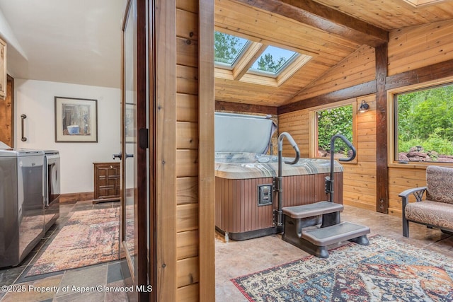 606 Dorais Way, Redstone, CO 81623 - living area featuring a skylight, wooden walls, washer and clothes dryer, and wood ceiling