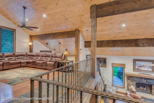 606 Dorais Way, Redstone, CO 81623 - living room with wood finished floors, wooden ceiling, a ceiling fan, vaulted ceiling, and a stone fireplace