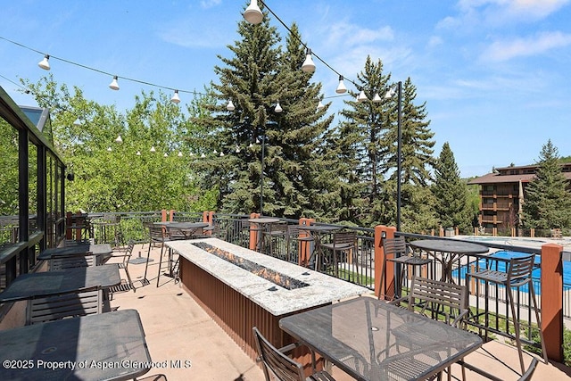 view of patio / terrace featuring outdoor dining area and an outdoor fire pit