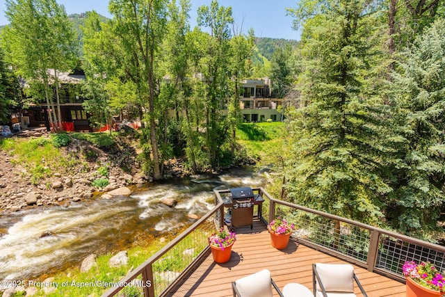 979 Queen St, Aspen, CO 81611 - wooden terrace featuring area for grilling, a water view, and a wooded view