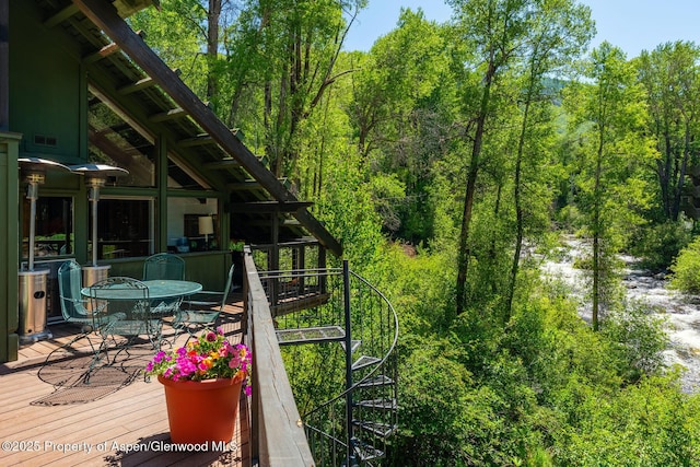 979 Queen St, Aspen, CO 81611 - wooden deck with outdoor dining space and a wooded view