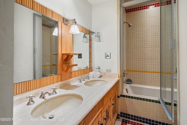 bathroom featuring tiled shower / bath, double vanity, tile patterned flooring, and a sink