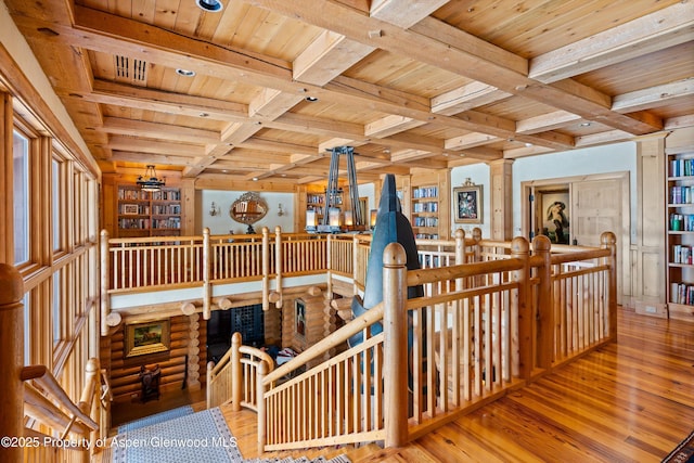 stairway featuring wood-type flooring, beam ceiling, wood ceiling, and coffered ceiling
