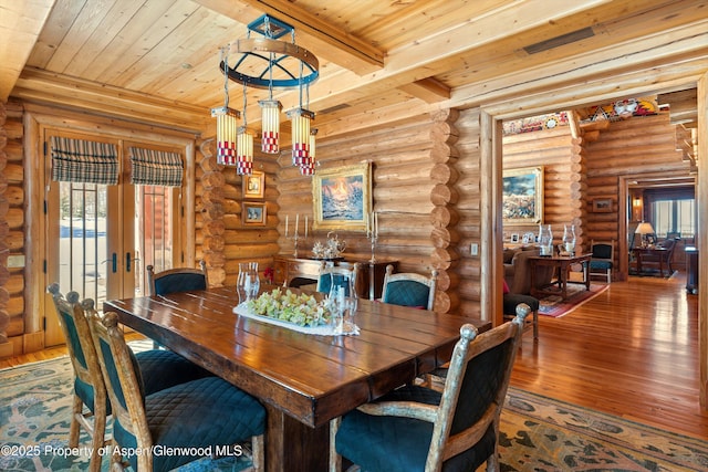 dining space with french doors, wooden ceiling, beam ceiling, and wood-type flooring
