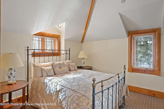 bedroom featuring lofted ceiling, baseboards, and carpet flooring