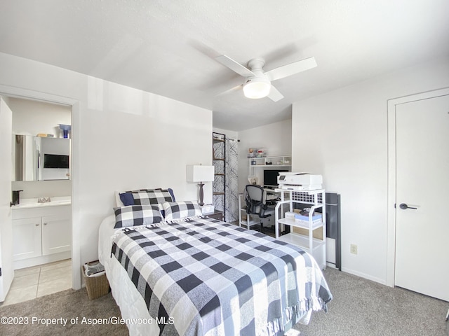 carpeted bedroom with ceiling fan, connected bathroom, and a sink