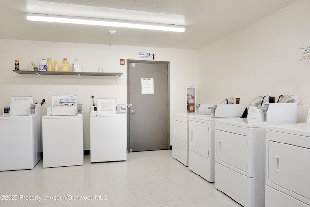 community laundry room with washing machine and clothes dryer