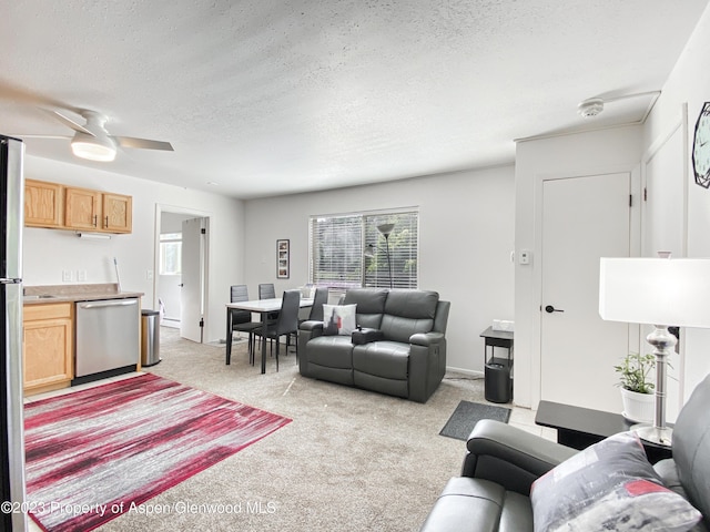 living area with a textured ceiling, a ceiling fan, and light carpet