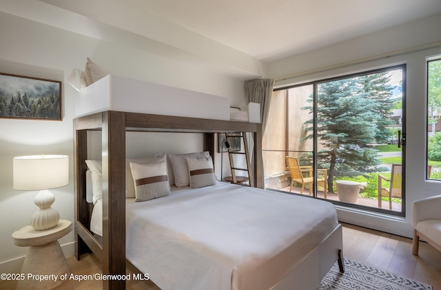 65 Harleston Grn Unit 51, Snowmass Village, CO 81615 - bedroom featuring multiple windows and wood finished floors