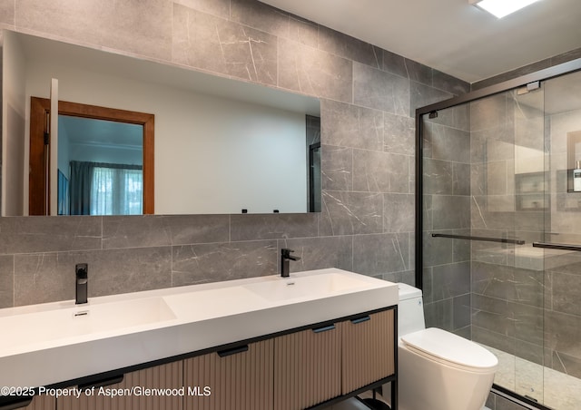 65 Harleston Grn Unit 51, Snowmass Village, CO 81615 - bathroom with tile walls, double vanity, a stall shower, and decorative backsplash