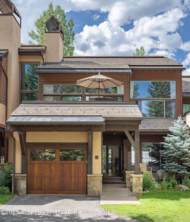 65 Harleston Grn Unit 51, Snowmass Village, CO 81615 - view of property featuring an attached garage