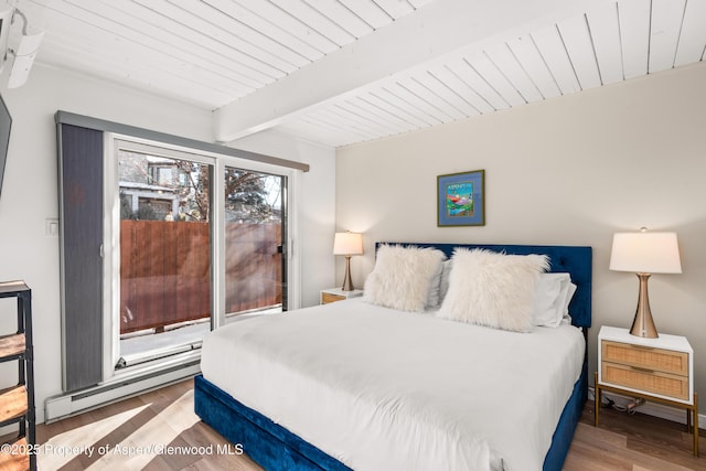630 E Cooper Ave Unit 4, Aspen, CO 81611 - bedroom with wood finished floors, a baseboard heating unit, and wood ceiling with exposed beams