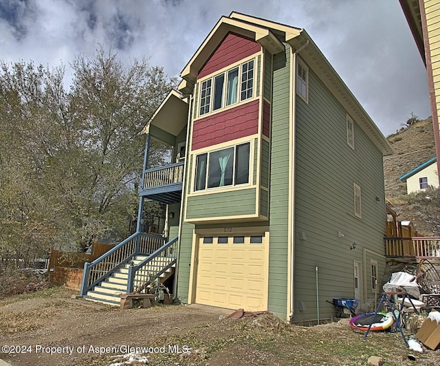 view of front of home with a balcony and a garage